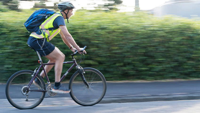 Person biking along Montana highway
