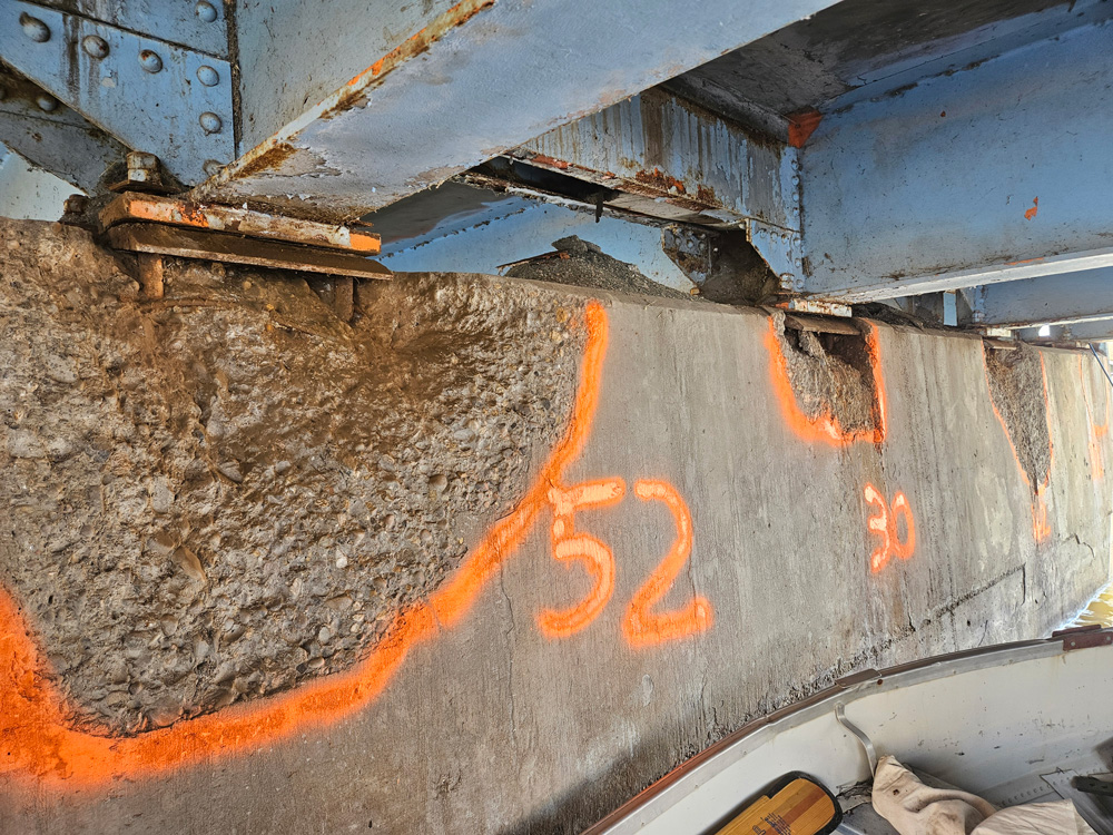 The pre-repair condition of the bridge’s concrete cap shows the loss of support under the girder bearings.