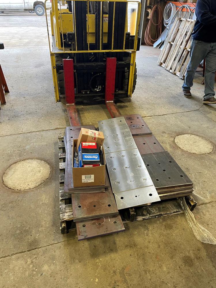 Steel plates and hardware ready for pickup at the Maintenance Shop.