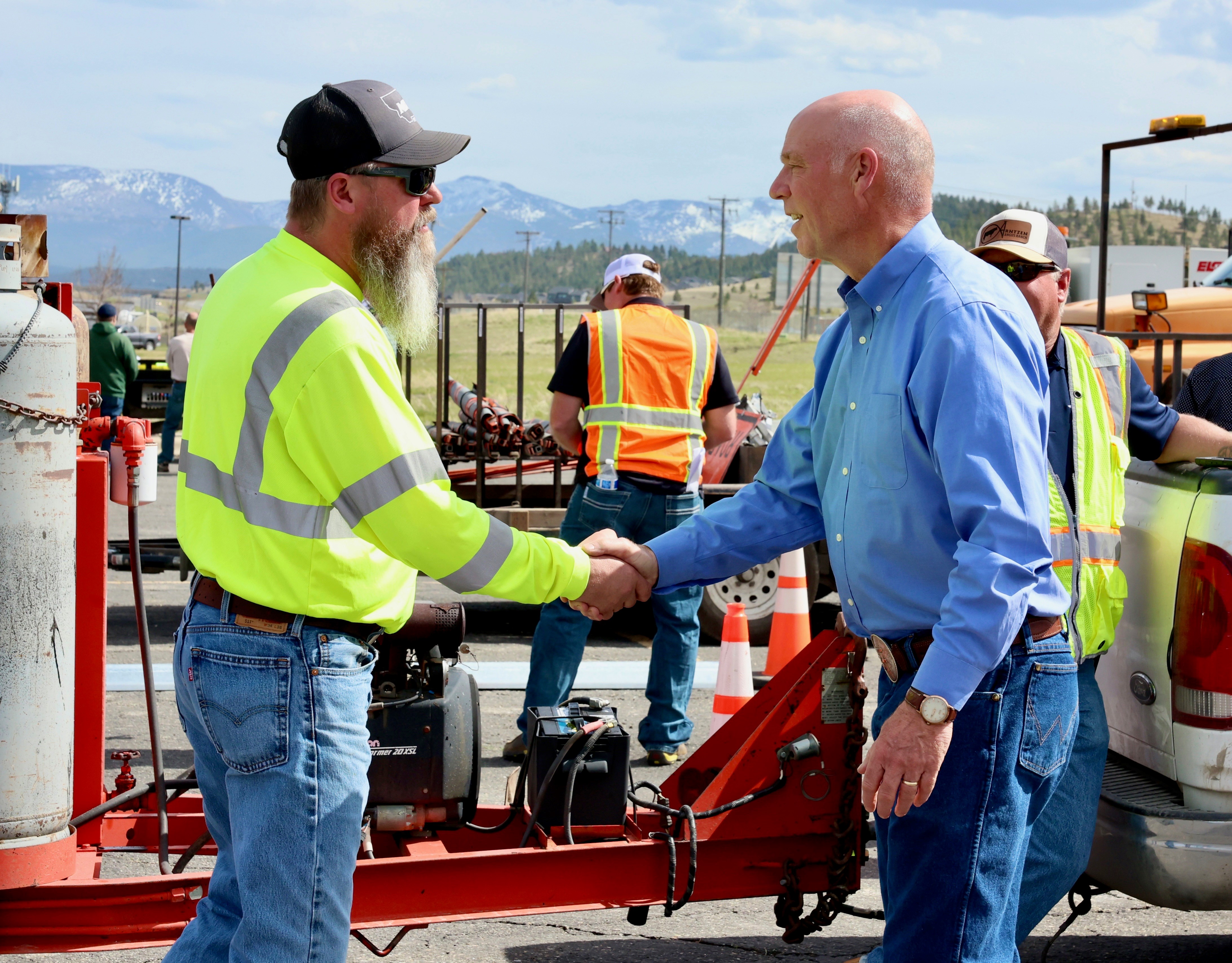 MDT Construction Employee (left) shaking hands with Montana Governor (right).