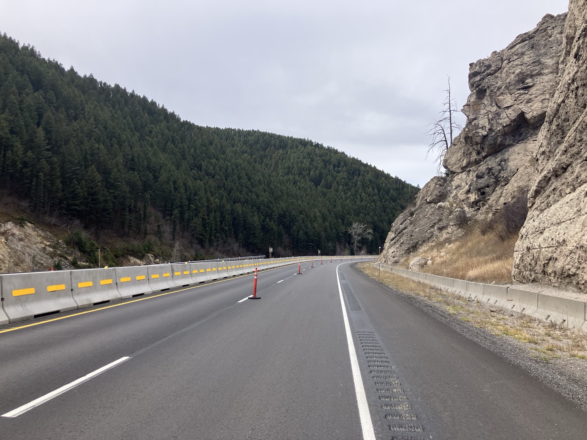 Photo of resurfaced I-90 with cones on the dashed centerline. 